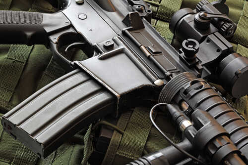 Close-up,Of,A,Scratched,M4a1,(ar-15),Carbine,And,Green,Military