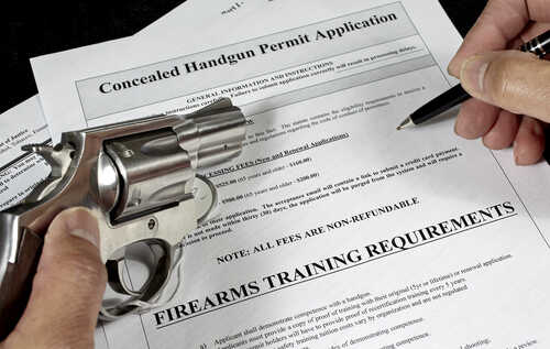 Man,With,Handgun,Firearm,Pistol,And,Concealed,Carry,Permit,Application