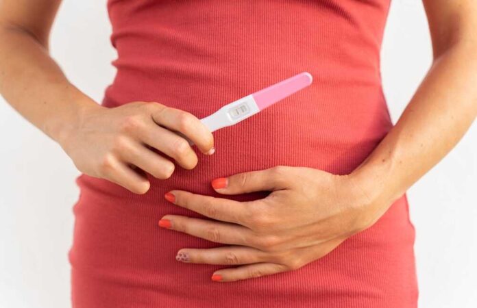 Young,Woman,Showing,A,Positive,Pregnancy,Test,Result,And,Her