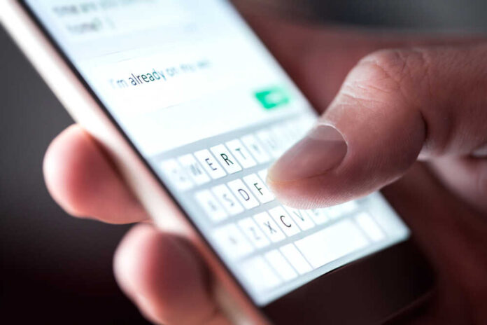 Man,Sending,Text,Message,And,Sms,With,Smartphone.,Guy,Texting
