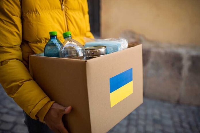 Close,Up,Of,Volunteer,Cyrrying,Box,With,Humanitarian,Aid,For
