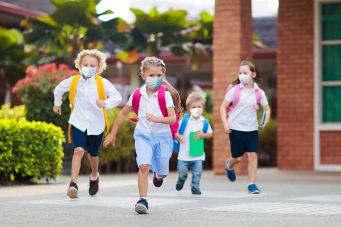 School,Child,Wearing,Face,Mask,During,Corona,Virus,And,Flu
