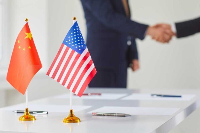 Flags,Of,China,And,America,Against,Background,Of,Handshakes,Of