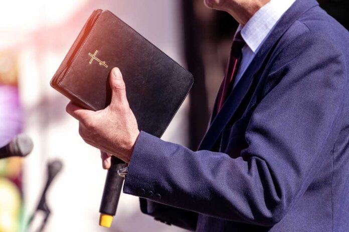 Pastor,With,A,Bible,In,His,Hand,During,A,Sermon.