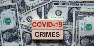 COVID-19 CRIMES on blocks, surrounded by dollar bills.