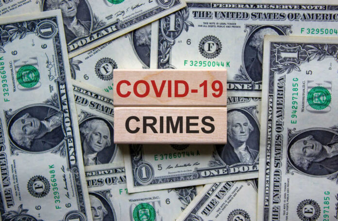 COVID-19 CRIMES on blocks, surrounded by dollar bills.