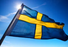 Swedish flag waving against a clear blue sky