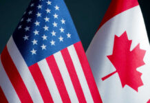 American and Canadian flags close together