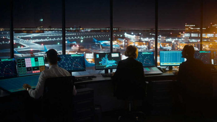 Air traffic controllers working at night airport tower