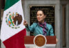 Mexico and US: Unlikely Allies Against Cartels? Person speaking at podium beside Mexican flag