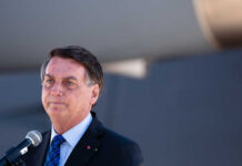 IMPRISONED Ex-President Rushed to ICU — Son ERUPTS A man speaking into a microphone at an outdoor event