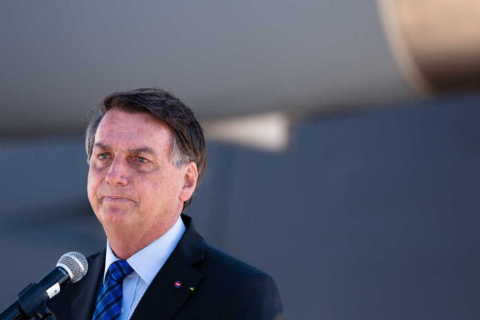 A man speaking into a microphone at an outdoor event