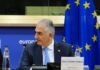 Crown Prince Reza Pahlavi attending a political meeting in front of the EU flag