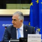 Crown Prince Reza Pahlavi attending a political meeting in front of the EU flag