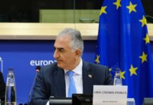 Exiled Prince’s Bold Move After Iran Strike Crown Prince Reza Pahlavi attending a political meeting in front of the EU flag