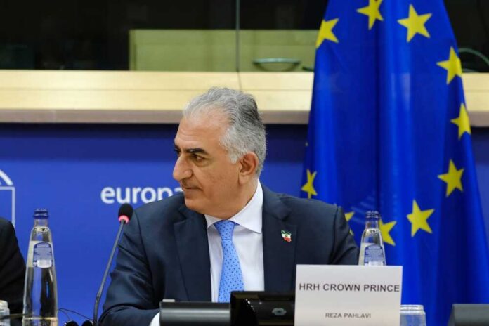 Crown Prince Reza Pahlavi attending a political meeting in front of the EU flag