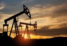Oil Leverage: Trump’s Risky Diplomatic Game Silhouetted oil pumps against a colorful sunset sky