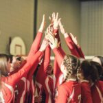 Trump’s Title IX Shake-Up: Women’s Sports at Stake Volleyball players celebrating with hands raised together