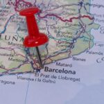 A red pushpin marking Barcelona on a map of Catalonia