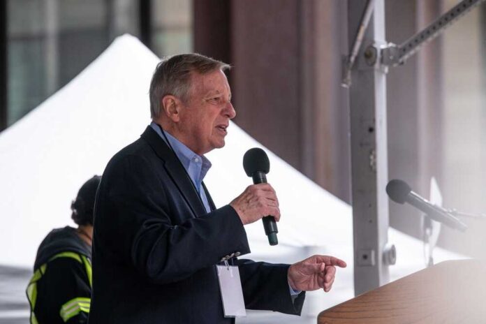 A man speaking into a microphone at an outdoor event