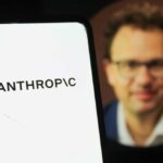 Pentagon’s “All Lawful Use” Demand Causes Uproar Close-up of a smartphone displaying the word 'ANTHROPIC' with a blurred portrait in the background