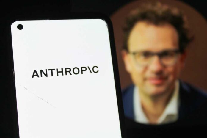 Close-up of a smartphone displaying the word 'ANTHROPIC' with a blurred portrait in the background
