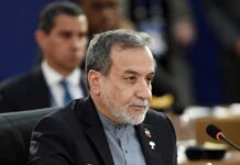 A man in formal attire participating in a political meeting