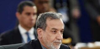 A man in formal attire participating in a political meeting
