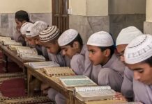 Iran’s Regime Exploits 12-Year-Olds for War Young students studying the Quran in a classroom setting