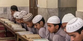 Young students studying the Quran in a classroom setting