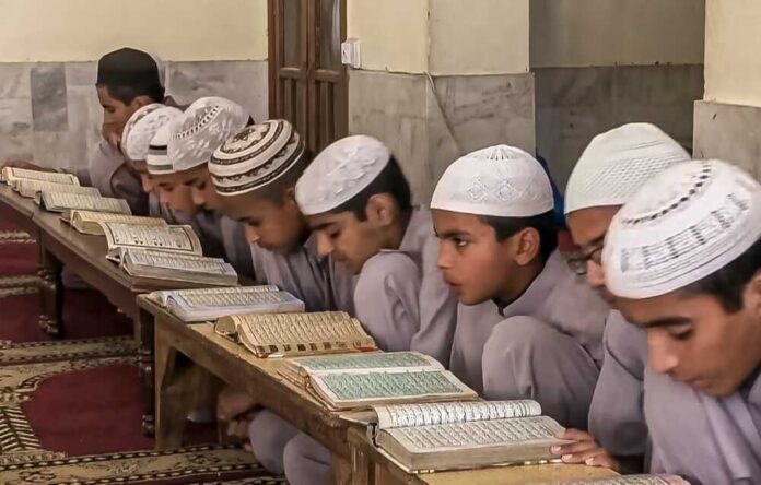 Young students studying the Quran in a classroom setting