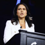 Democrat to Trump Loyalist: Gabbard’s Stunning Rise Person speaking at a podium with microphone.