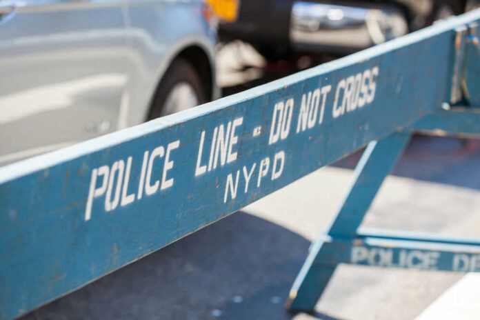 Blue NYPD barricade with Police Line - Do Not Cross.