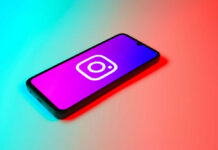 Smartphone displaying Instagram logo in colorful lighting