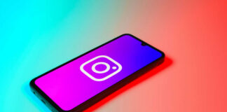 Smartphone displaying Instagram logo in colorful lighting