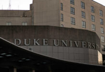 Sign displaying 'Duke University' on a modern building
