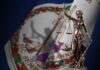 Bronze statue of Lady Justice in front of the Virginia state flag