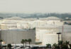 A view of large industrial fuel storage tanks in an urban area