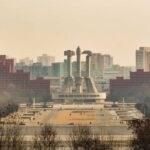 View of a large monument surrounded by buildings in Pyongyang