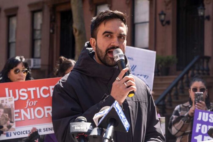 Man speaking into a microphone at a protest for senior justice