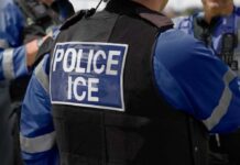 Routine ID Visit Triggers Shocking ICE Arrest Close-up of a police officer's vest with 'POLICE ICE' label