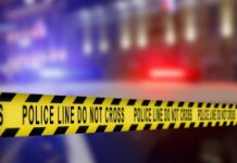 Yellow police caution tape with the text 'POLICE LINE DO NOT CROSS' in a blurred background