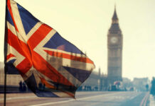 Union Jack flag waving in front of Big Ben in London