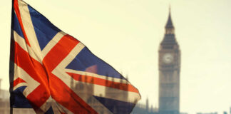 Union Jack flag waving in front of Big Ben in London