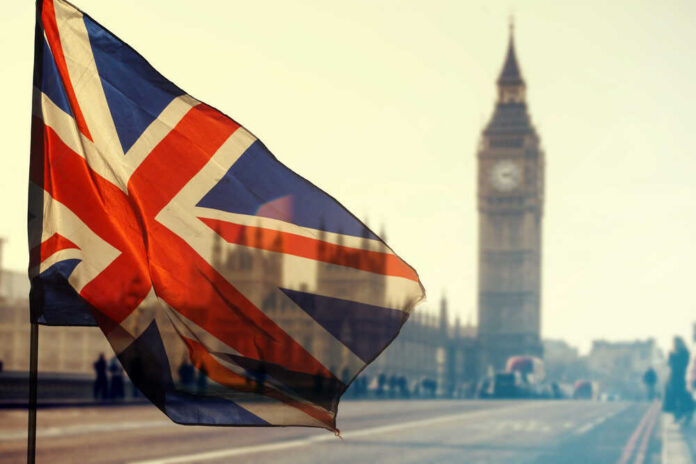 Union Jack flag waving in front of Big Ben in London