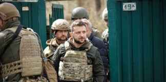 Group of soldiers, including Volodymyr Zelenskyy, wearing tactical gear.