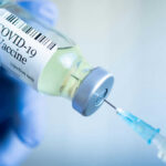 COVID-19 vaccine vial and syringe.