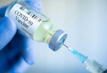 COVID-19 vaccine vial and syringe.