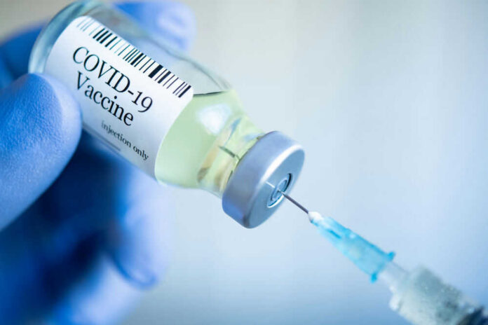 COVID-19 vaccine vial and syringe.