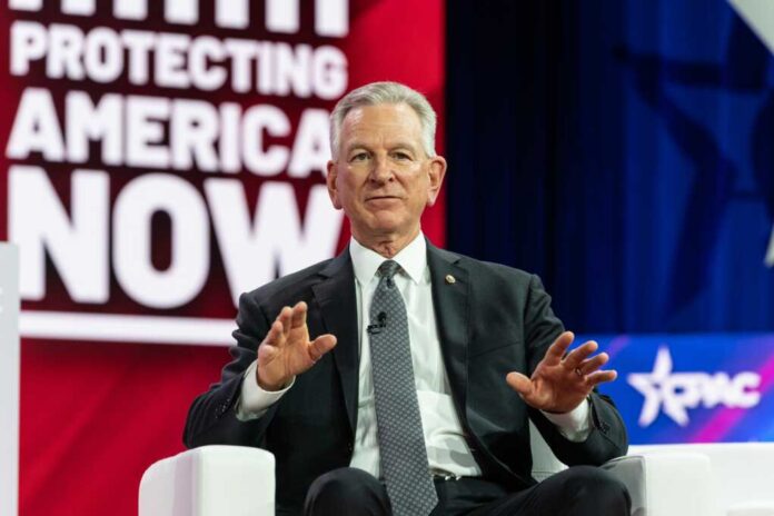 Us,Senator,Tommy,Tuberville,Speaks,On,The,1st,Day,Of Man in suit speaking on stage with hands raised